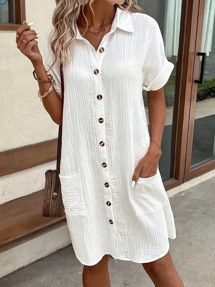 Stylish women's shirtdress featuring a button-front, collar, & practical pockets. Perfect for summer fashion.