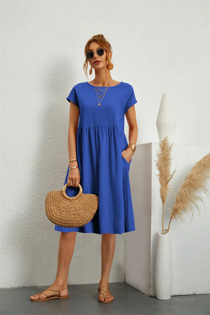 Women's knee-length casual dress with convenient pockets, offering effortless style & comfort.