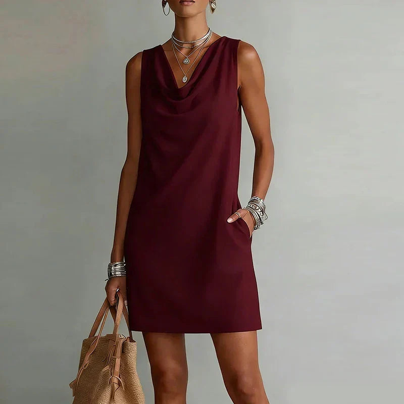 Casual women's summer mini dress with a draped neck & pockets, ideal for beach wear or a relaxed vacation outfit.