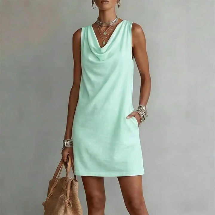 Versatile women's mini dress with a draped neckline and pockets, perfect as a casual summer or vacation outfit.