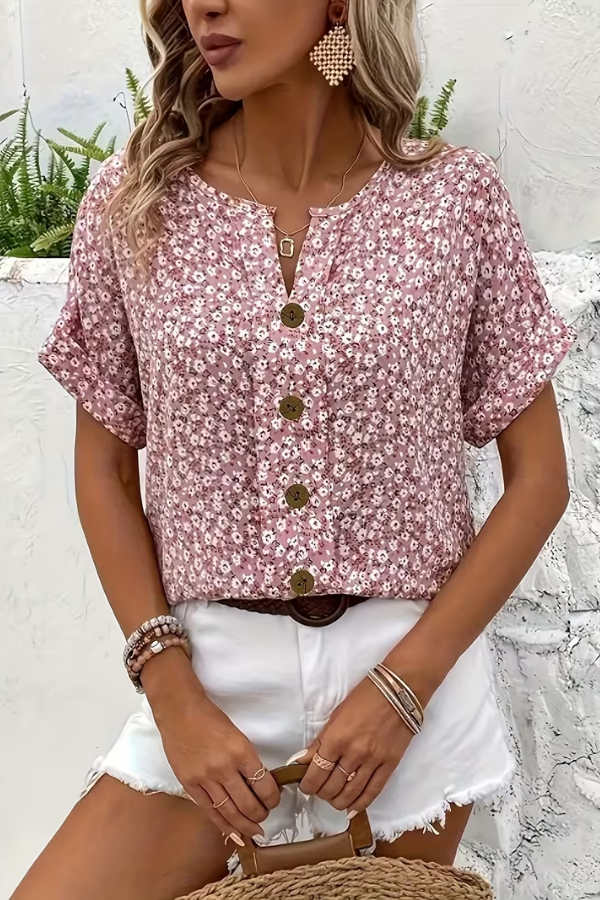 Vibrant floral pattern on a women's breezy summer blouse. Short sleeve, comfortable for warm weather.