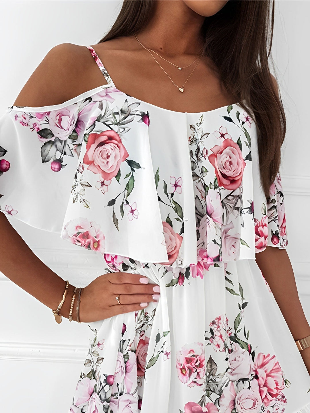 Detailed view of the cold shoulder design on a women's romantic floral mini dress with ruffles.