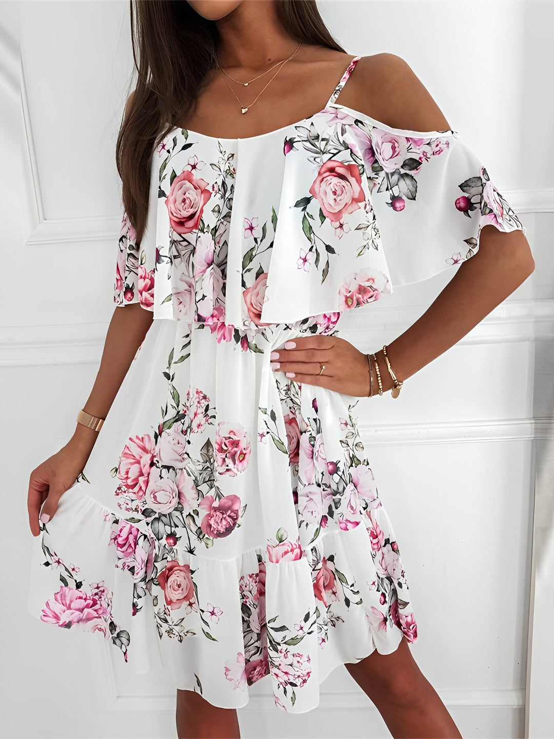 Flowy tiered ruffles on a women's short floral cold shoulder mini dress, ideal for vacation.