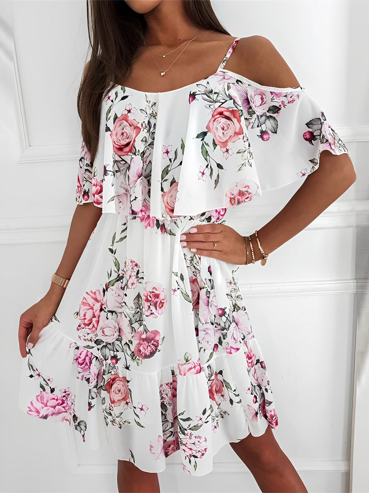 Flowy tiered ruffles on a women's short floral cold shoulder mini dress, ideal for vacation.