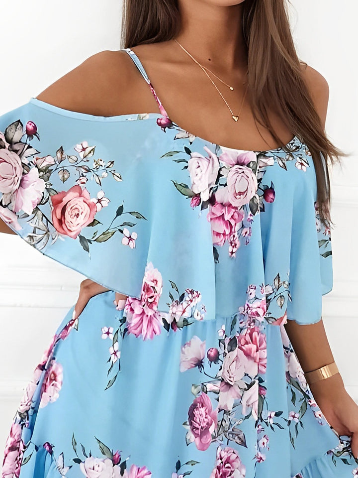 Close-up of the light fabric and elegant floral print of this women's cold shoulder mini dress.