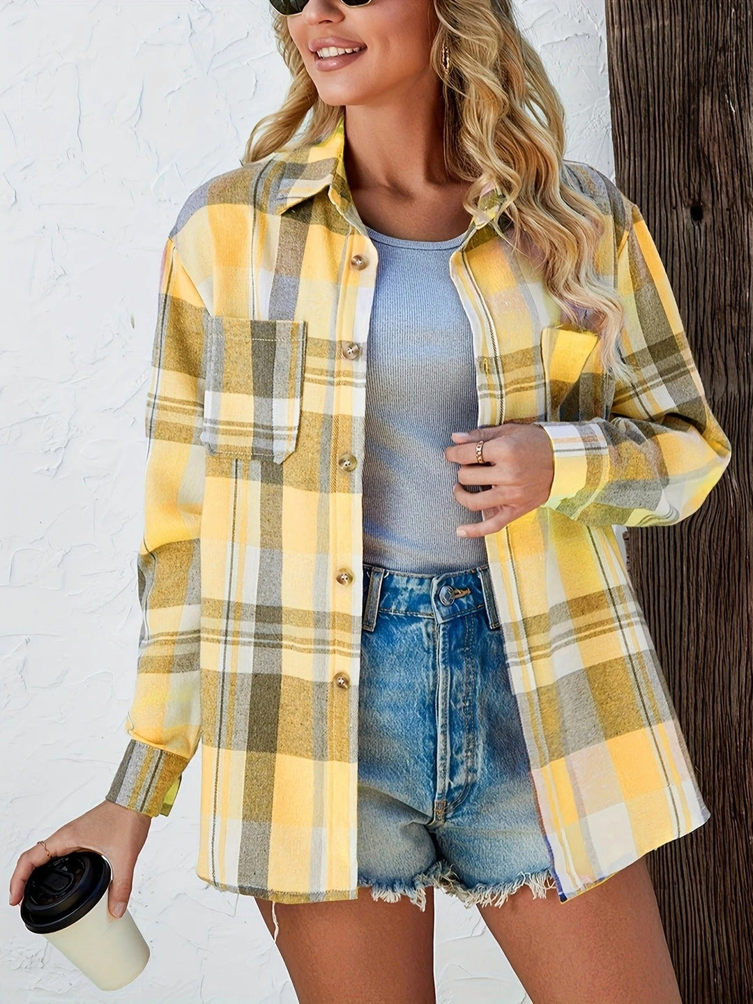 Trendy women's plaid shirt with button-down front, long sleeves, and a comfortable, versatile design.