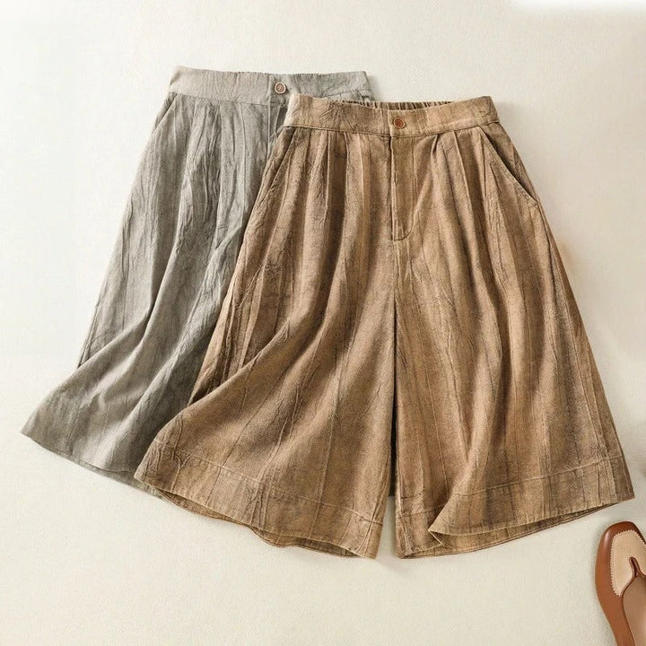 Casual women's tie-dye high-waist shorts. Relaxed fit for warm weather, blending brown and gray patterns.