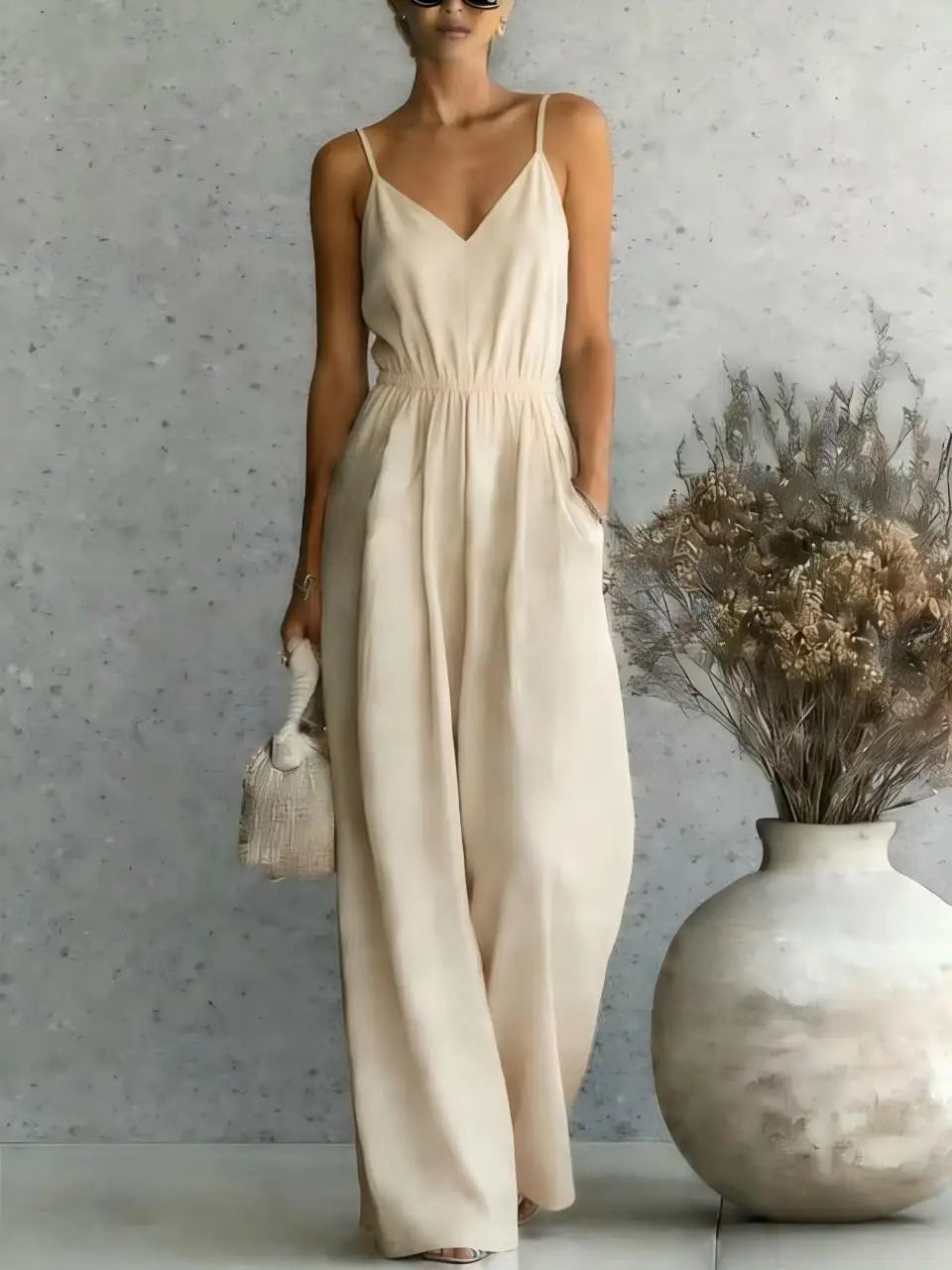 Comfortable women's one-piece wide leg jumpsuit featuring a V-neck, great for summer fashion & relaxed days.