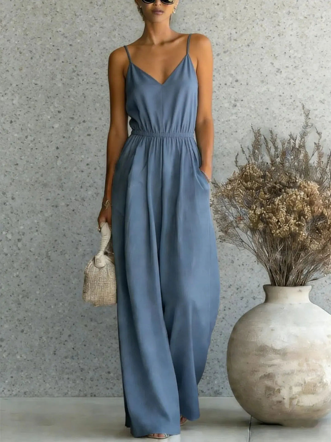 Effortless women's wide leg jumpsuit with V-neck & sleeveless design, offering ultimate comfort & style.