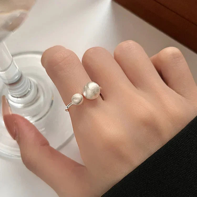 Women's Elara brushed silver ring with delicate connected pearls. Elegant sterling silver pearl jewelry.