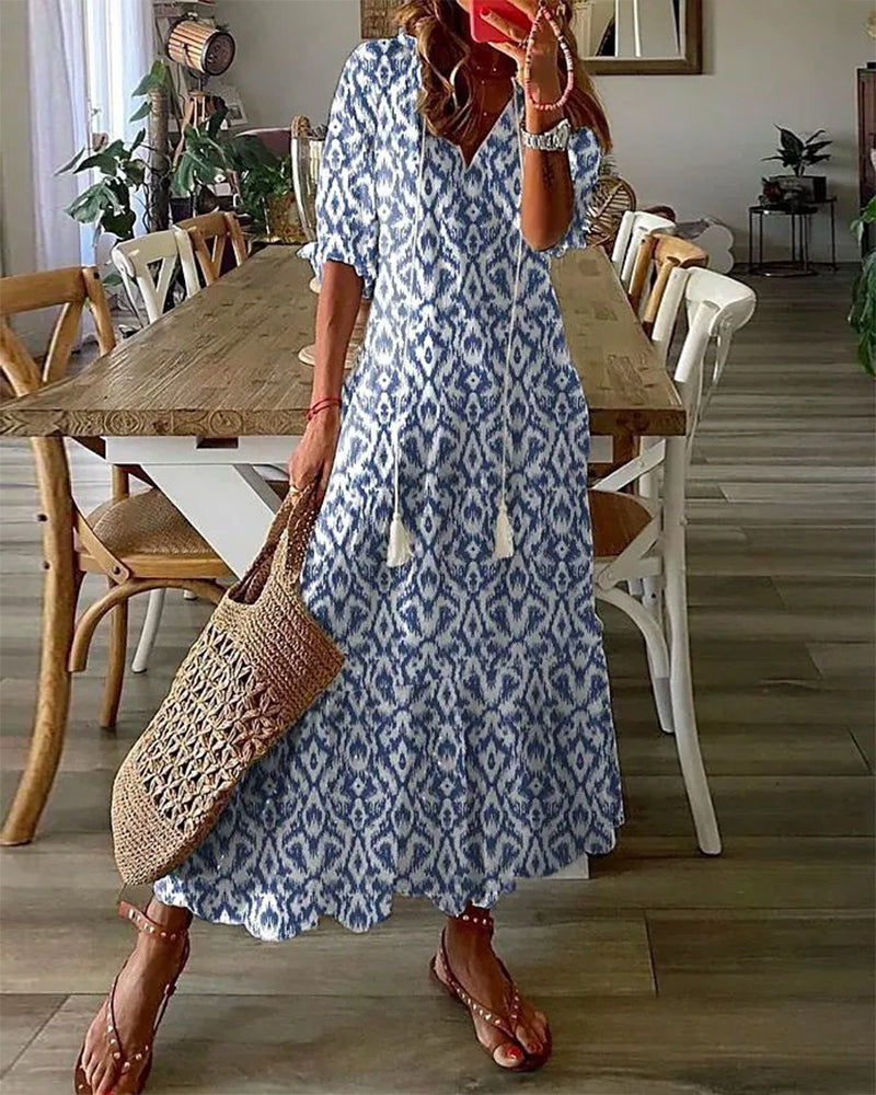 Women's Elara flowy maxi dress in a vibrant print, perfect for effortless summer style & vacation wear.