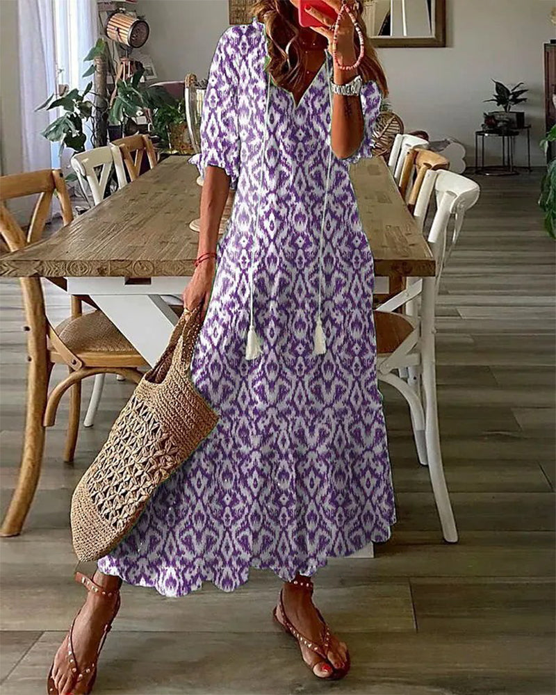 Woman wearing a flattering Elara flowy maxi dress. Effortless style, perfect as a casual or elegant summer dress.