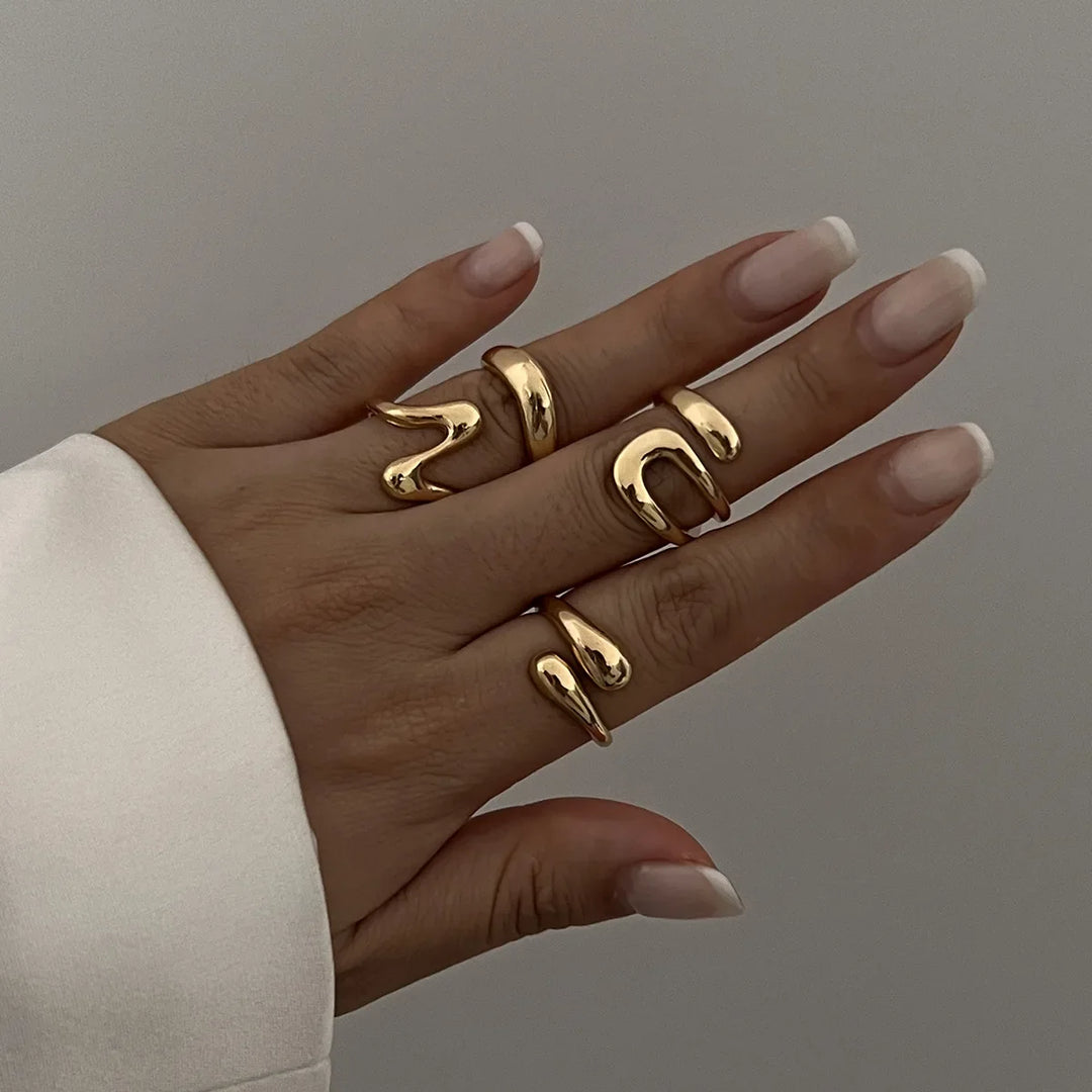 Gold Elavon Fluid Metal Ring Set, modern sculptural design, elegant women's fashion jewelry.