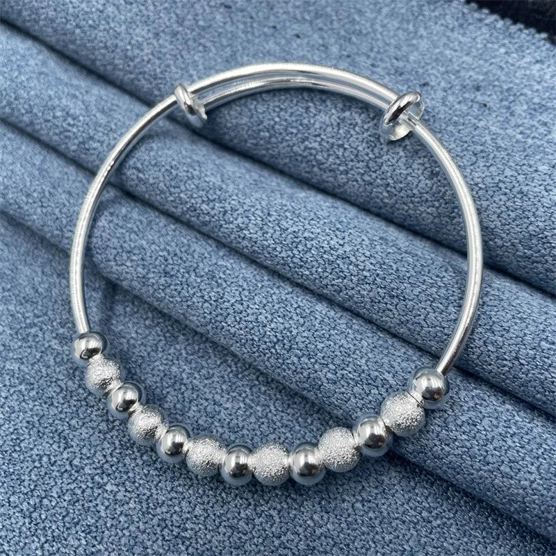 Beautiful women's silver party bracelet with luxurious charm, presented as an elegant gift accessory.