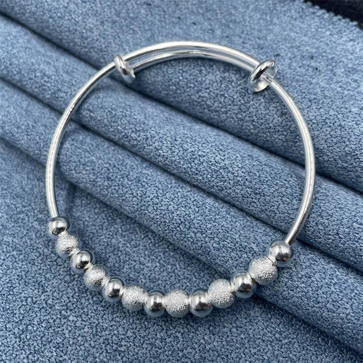 Beautiful women's silver party bracelet with luxurious charm, presented as an elegant gift accessory.