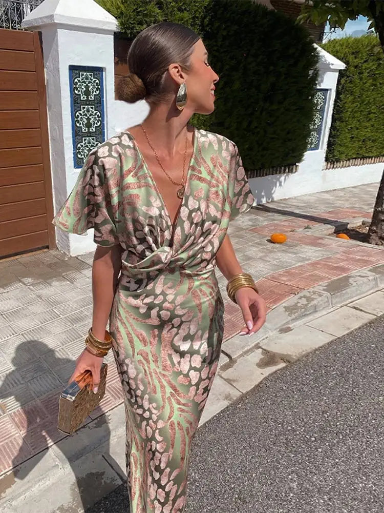 Women's elegant abstract printed wrap midi dress, relaxed fit for summer occasions.