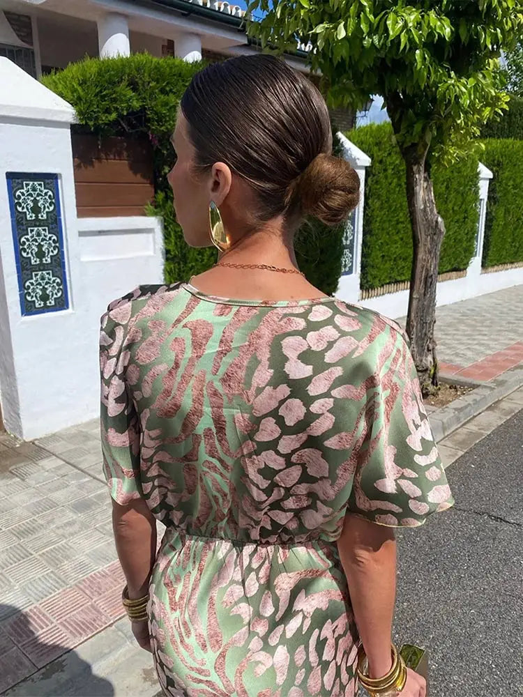 Stylish women's printed wrap midi dress with abstract pattern, ideal for elegant summer events.