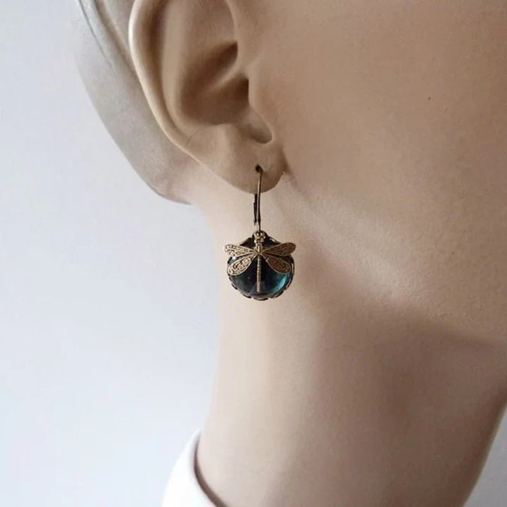Spherical antique gold dragonfly earrings. Elegant vintage women's jewelry, nature-inspired, ideal gift for her.