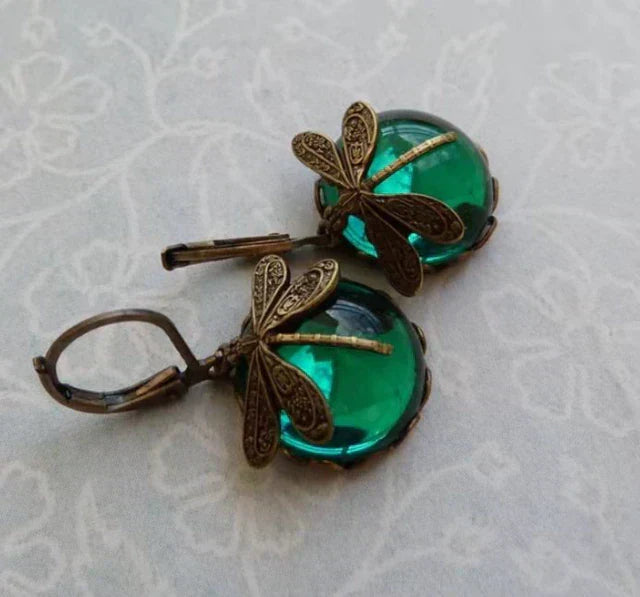 Stylish antique gold dragonfly earrings. Vintage-inspired elegant women's jewelry, nature motif.