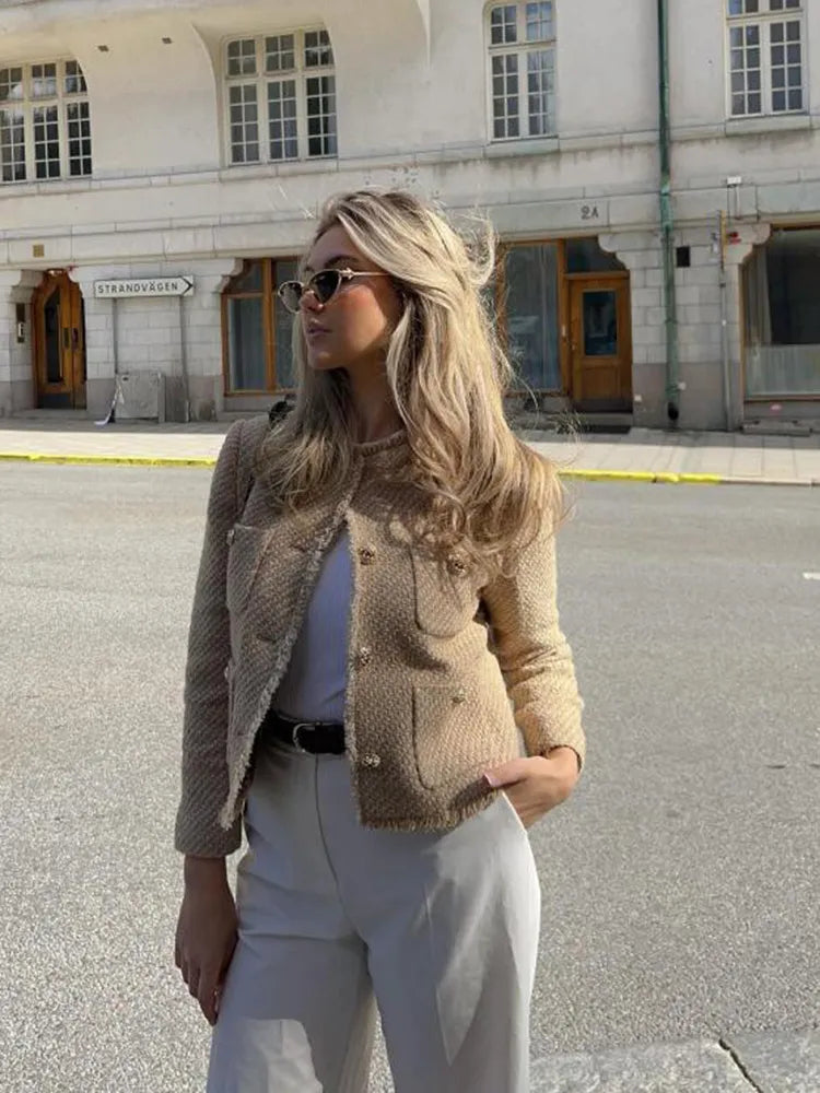 Stylish women's elegant tweed jacket with gold buttons, ideal for ladies seeking chic and classic outerwear.
