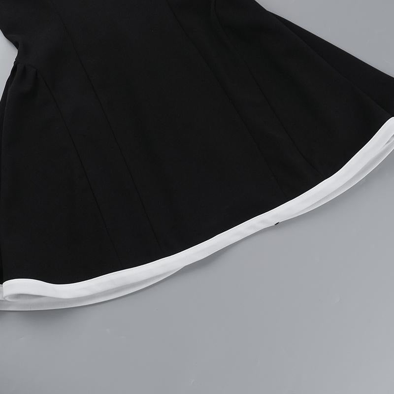 Elegant women's mini dress, black with stylish contrast neckline, perfect for sophisticated evening events.