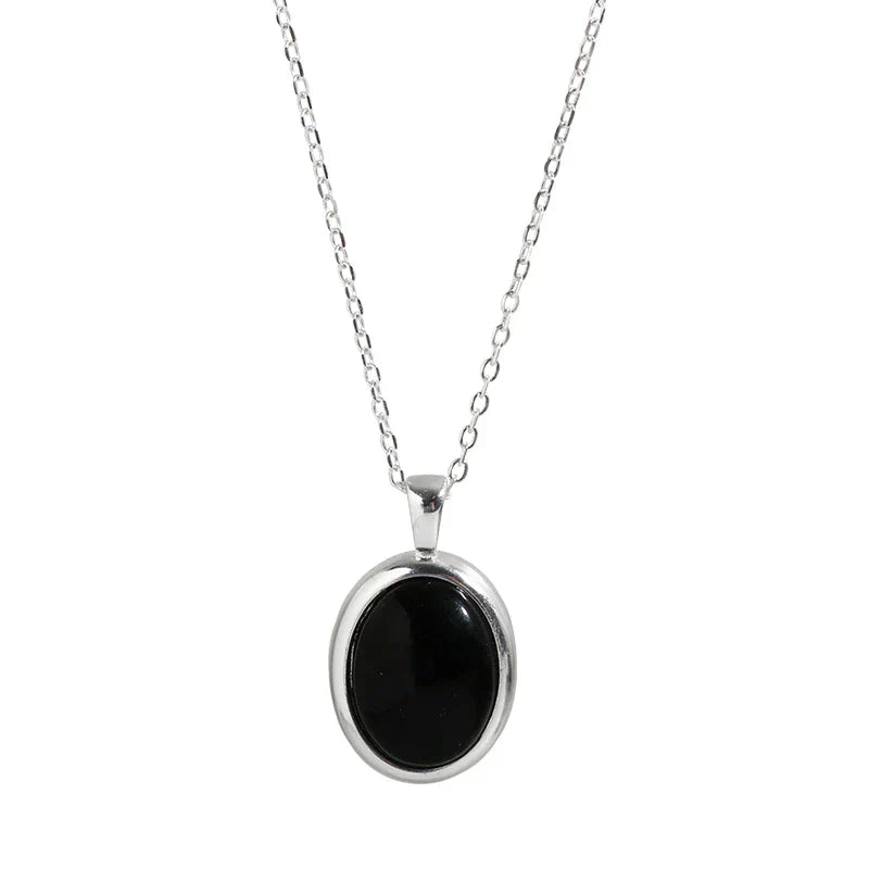 Women's elegant black opal pendant necklace, a shimmering gemstone fine jewelry fashion accessory.