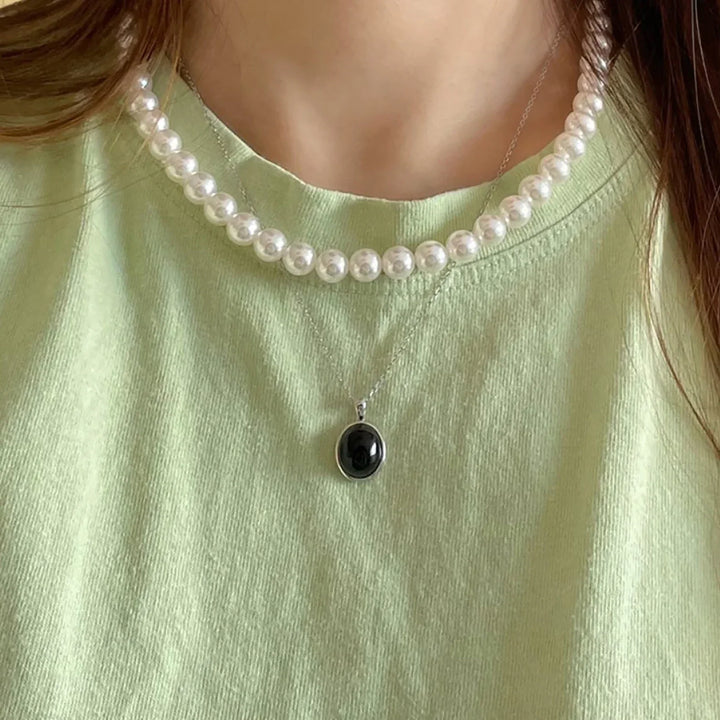 Model wearing a beautiful black opal pendant necklace, perfect for elegant women's jewelry fashion.