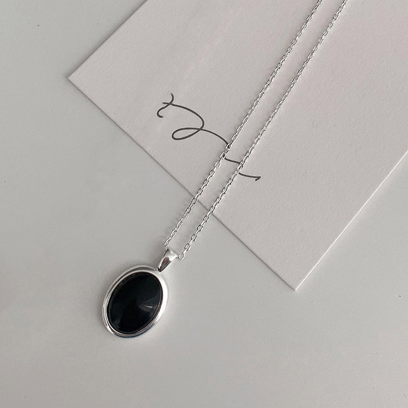 Adjustable chain black opal pendant necklace, a fine jewelry piece for women's elegant fashion accessory.