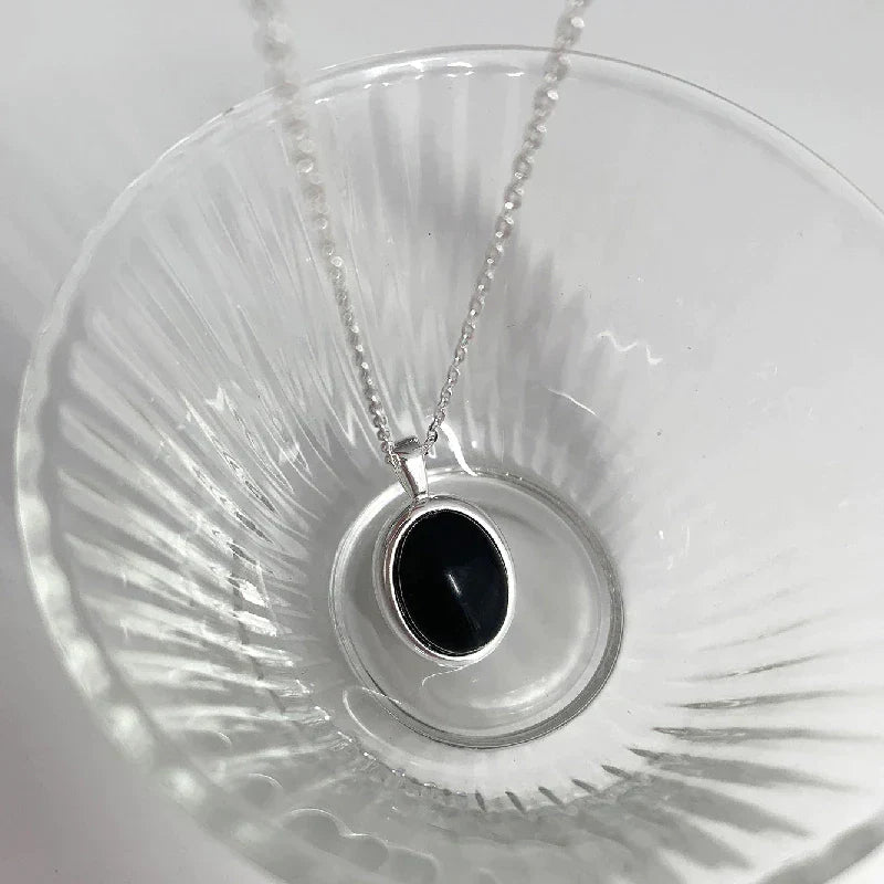 Versatile black opal pendant necklace, perfect elegant women's jewelry for any occasion or outfit.