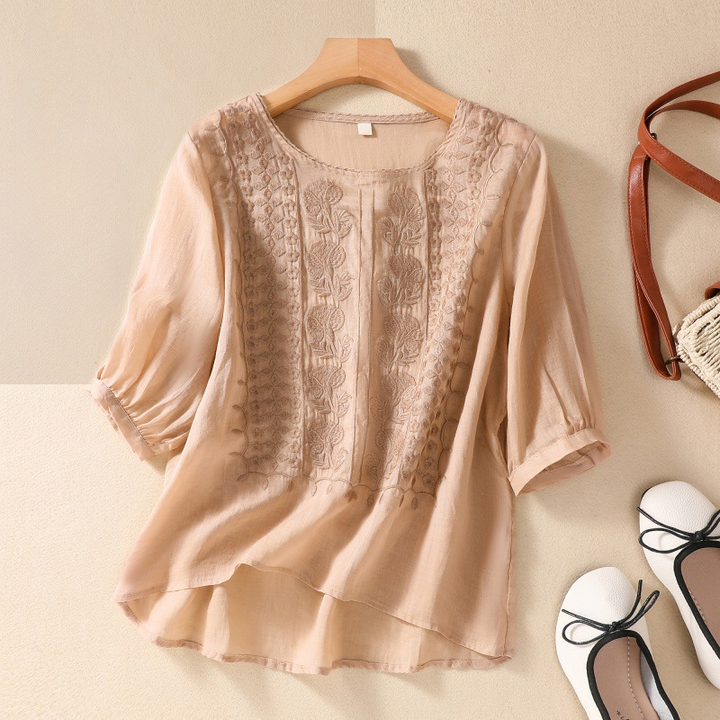 Casual yet elegant women's lace top, a stylish short sleeve blouse perfect for any warm weather occasion.