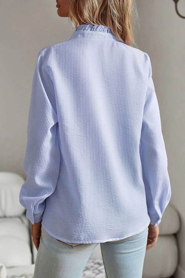 Versatile women's blue blouse, an elegant fashion top for both professional workwear and casual outfits.