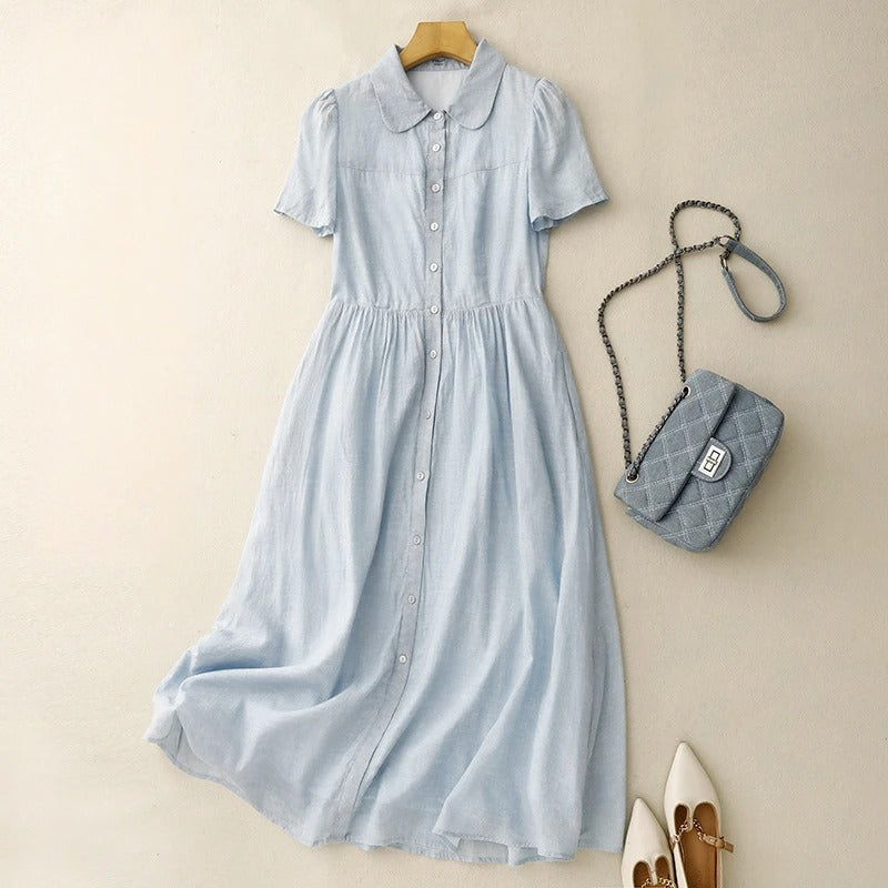 Women's elegant blue button-front summer dress, perfect for effortless casual style & vacation wear. Flowy fabric.