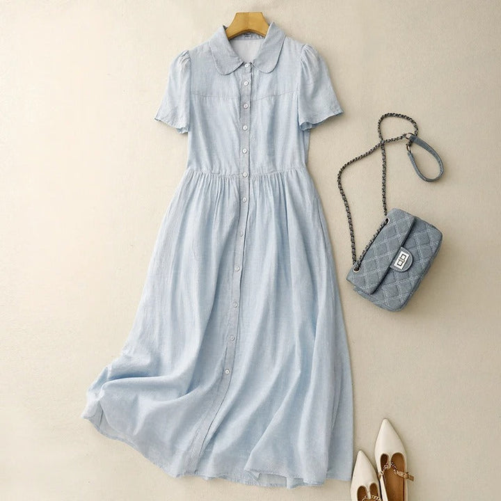 Women's elegant blue button-front summer dress, perfect for effortless casual style & vacation wear. Flowy fabric.