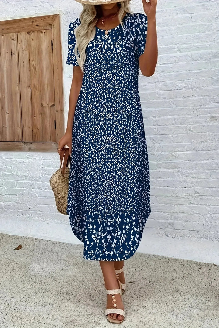 Flowing women's blue floral maxi dress, elegant summer style for ladies. Long, comfortable vacation wear.