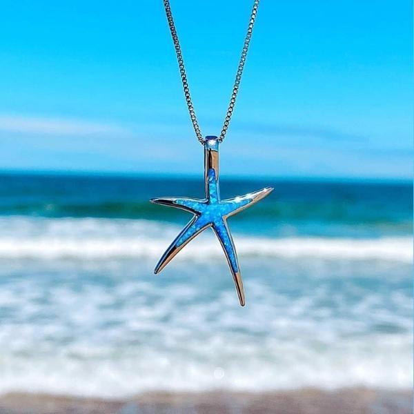 Women's elegant blue opal starfish pendant necklace. Ocean-inspired jewelry with a shimmering sea-themed design.