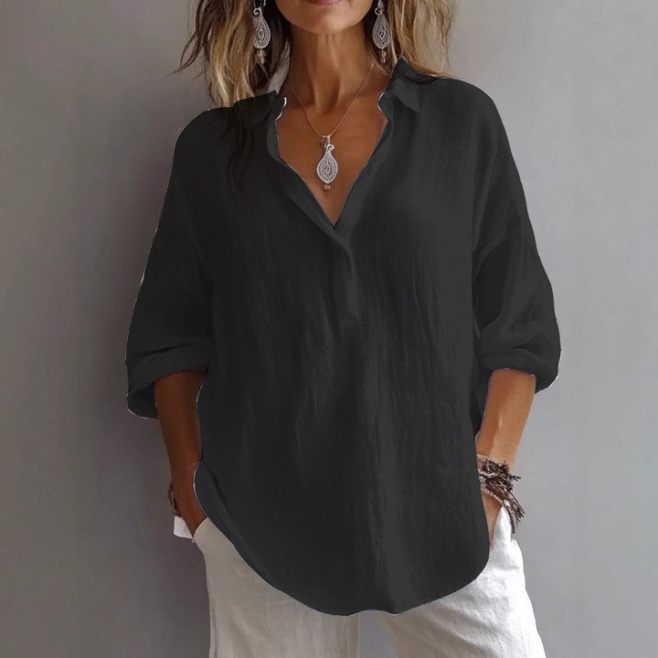 Summer-ready women's button-down shirt with wide, flowy sleeves, offering a chic and relaxed fit.