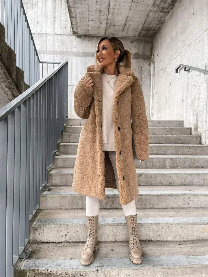 Casual women's long coat with relaxed fit, ideal elegant outerwear for fall layering.
