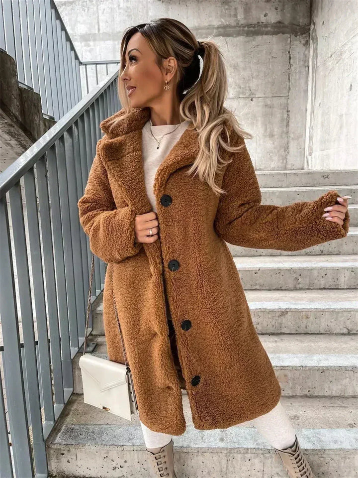 Chic ladies longline jacket, a versatile button-closure coat for fall and winter style.
