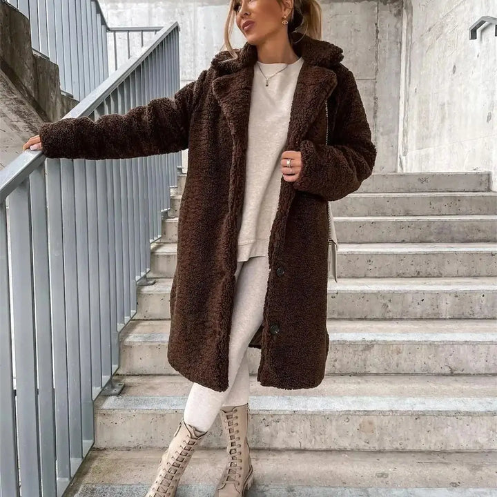 Women's stylish longline winter coat, an elegant casual jacket with button detail.