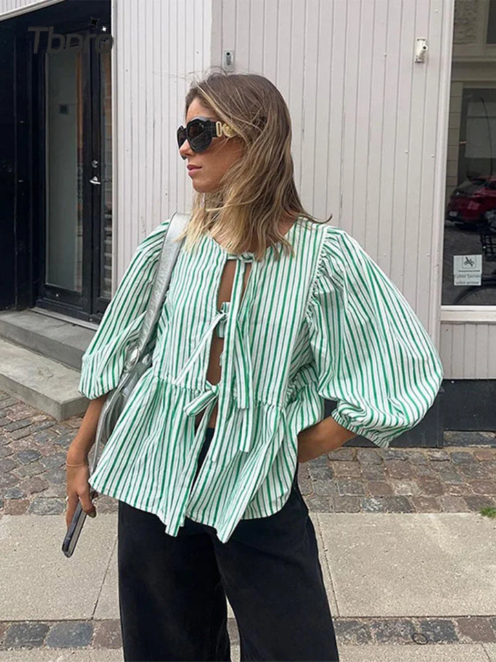 Women's elegant checked puff sleeve blouse, versatile long sleeve fashion top.