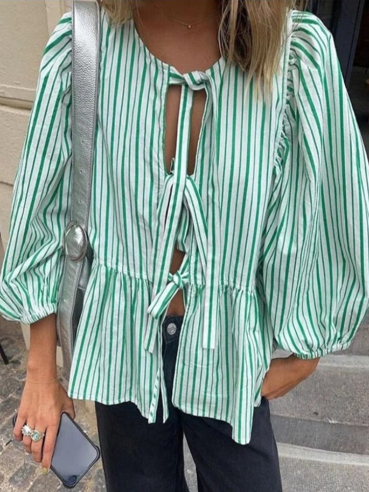Women's long sleeve blouse featuring a trendy checked pattern and chic puff sleeves.