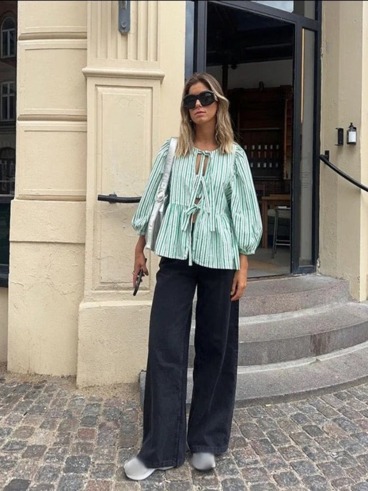 Versatile women's checked blouse with puff sleeves, suitable for elegant or casual looks.