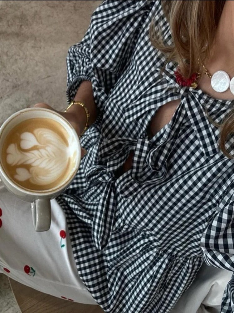 Fashionable women's checked blouse with elegant puff sleeves. A must-have versatile top.
