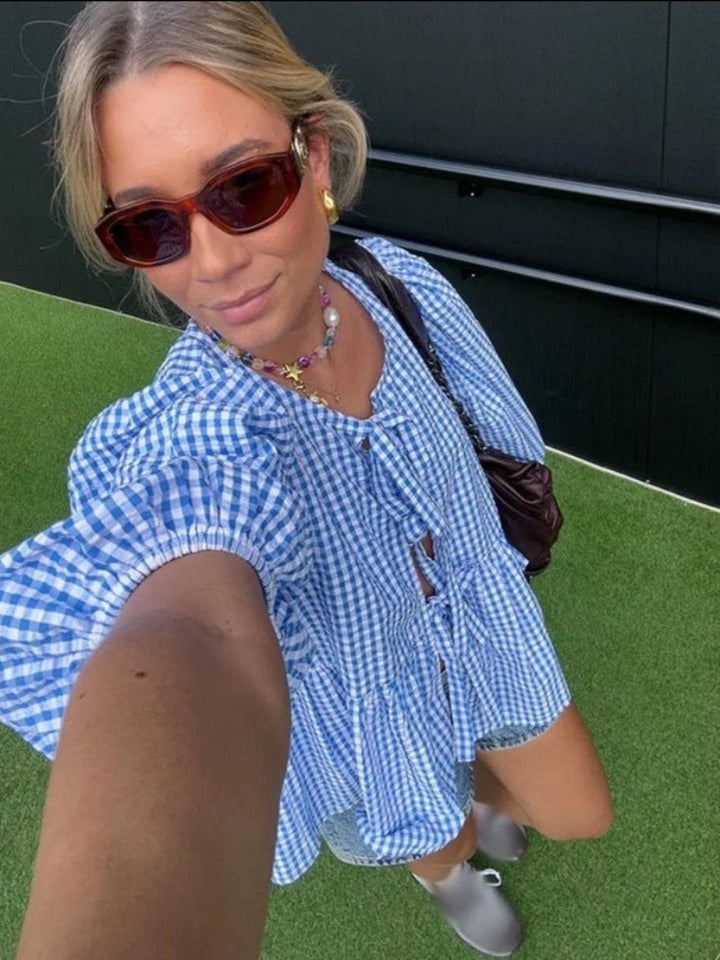 Elegant women's checked long sleeve blouse with eye-catching puff sleeves for any occasion.