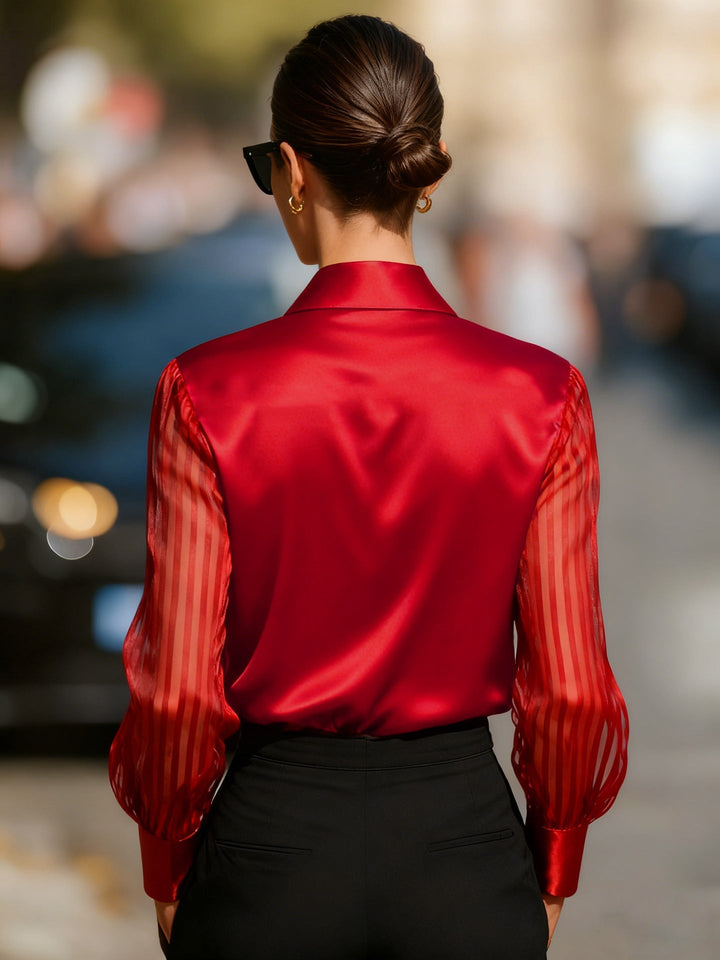 Stylish flowing women's blouse with an elegant collar and captivating sheer stripe sleeves.