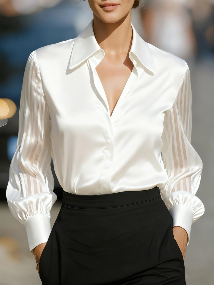 Stylish women's button-up blouse featuring sophisticated collar and chic sheer striped sleeves.