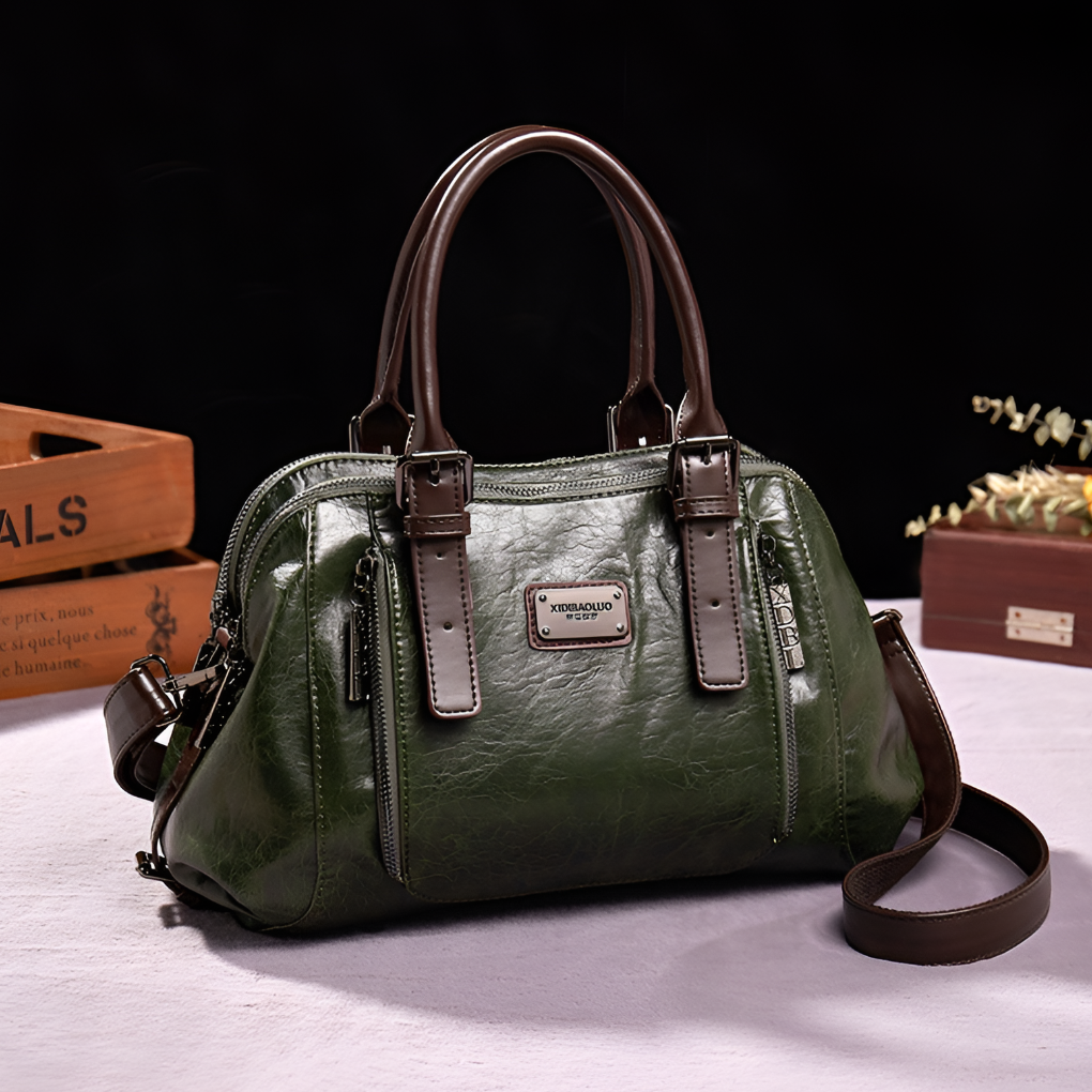 Close-up of a women's classic croc embossed Boston handbag showcasing texture, top handle, and golden hardware.