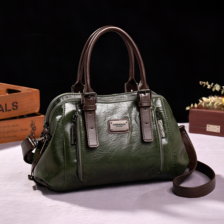 Close-up of a women's classic croc embossed Boston handbag showcasing texture, top handle, and golden hardware.