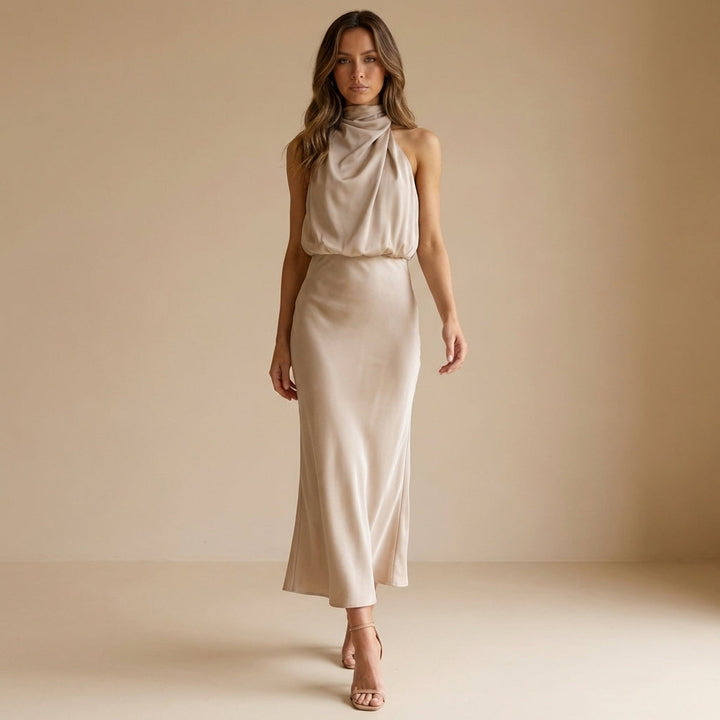 Stylish women's sleeveless draped midi dress, featuring a halter neck and blouson waist, for parties.