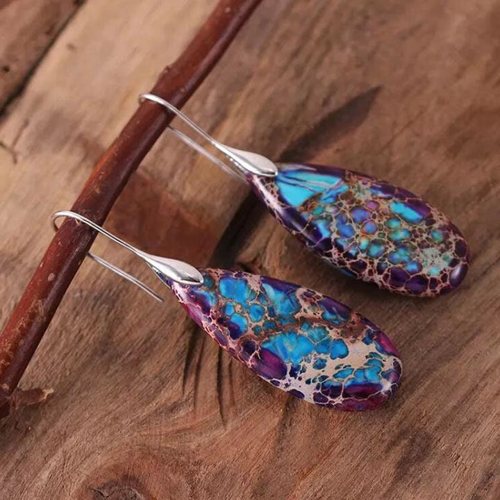 Stylish women's drop earrings featuring natural emperor stone & silver plated finish.